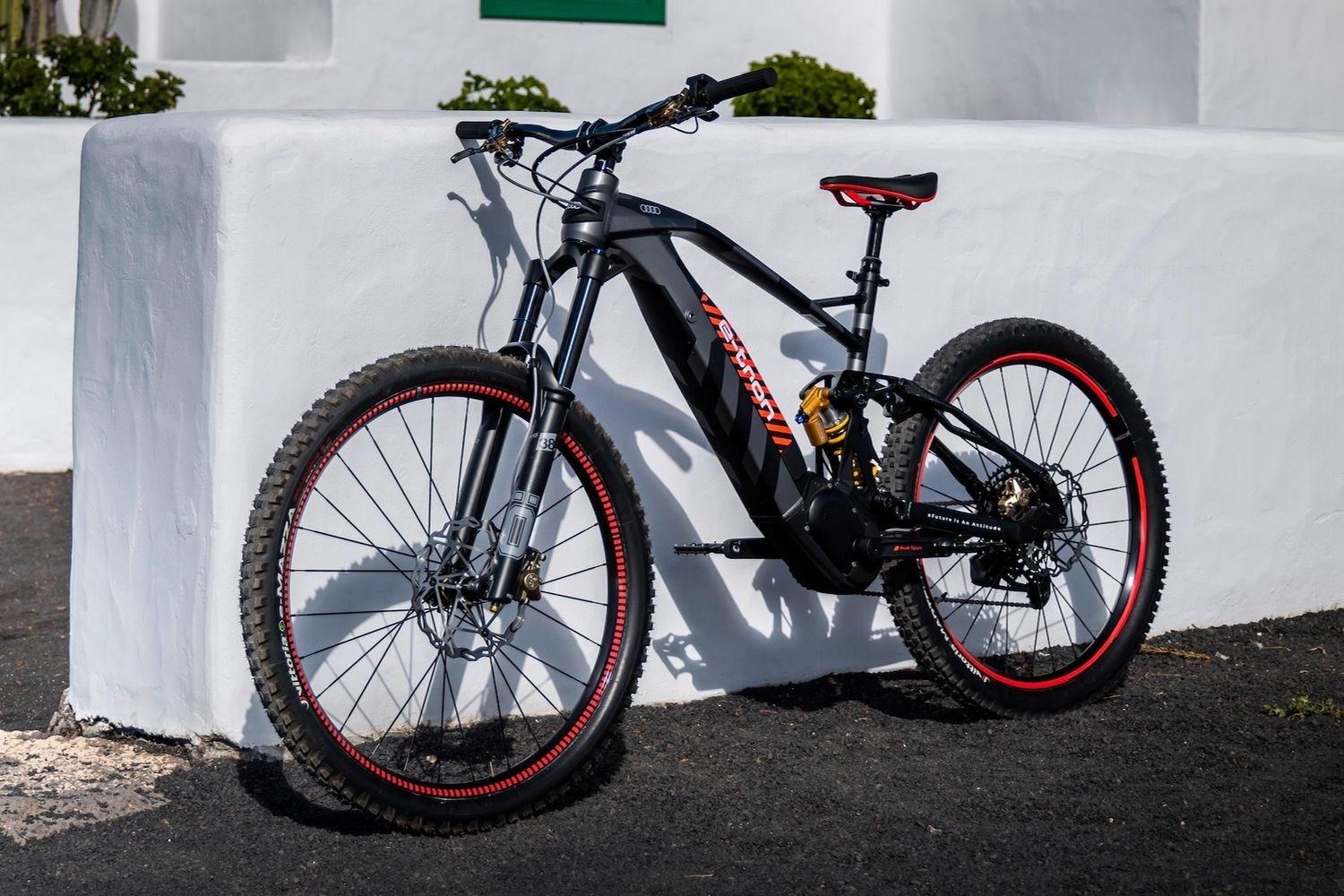 Audi electric mountain bike powered by Fantic leaning against wall