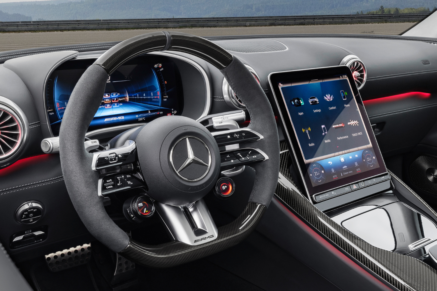 Leather interior steering wheel and two driver displays inside the Mercedes-Benz AMG GT Coupe.