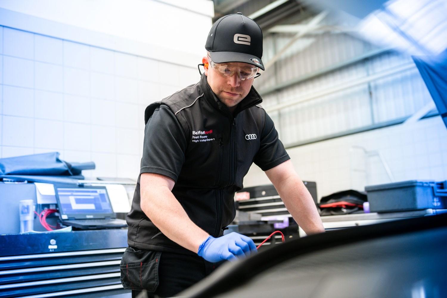 Audi Repair Specialist checks under the hood of Audi vehicle during service at Belfast Audi