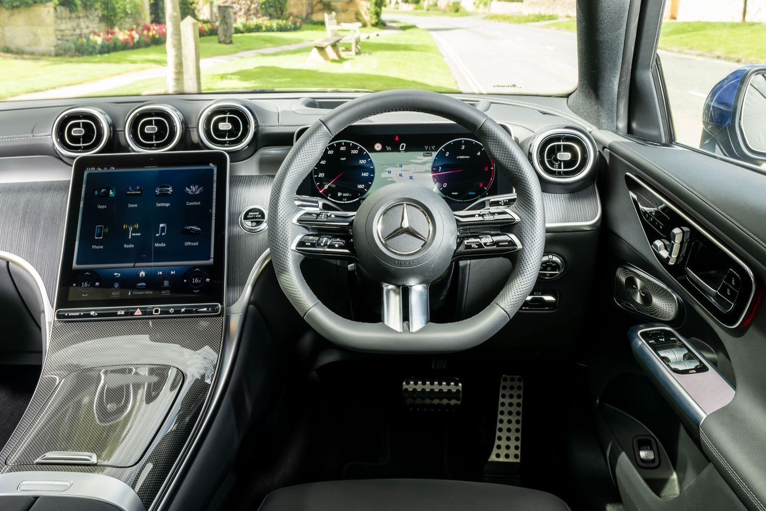 Steering wheel and 2 infotainment displays in a Blue Mercedes-Benz GLC Coupé.