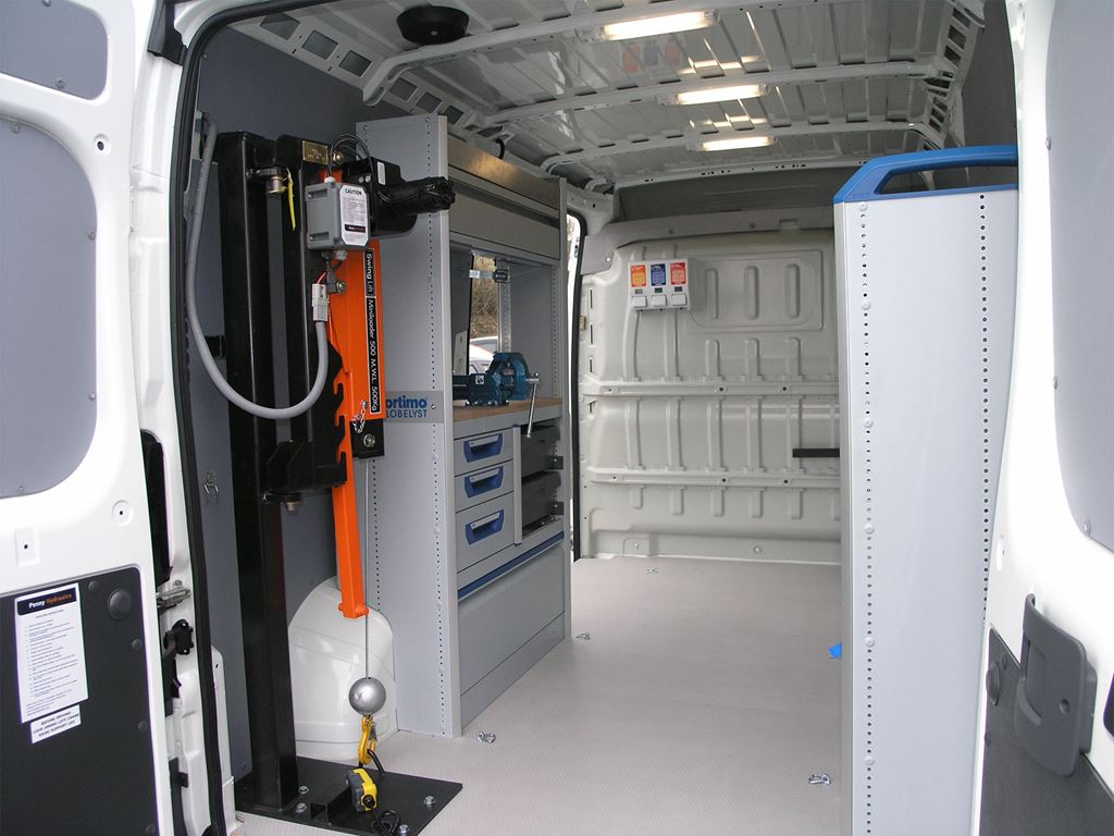 Work van interior fitted with lifting pole system, storage drawers and racking.