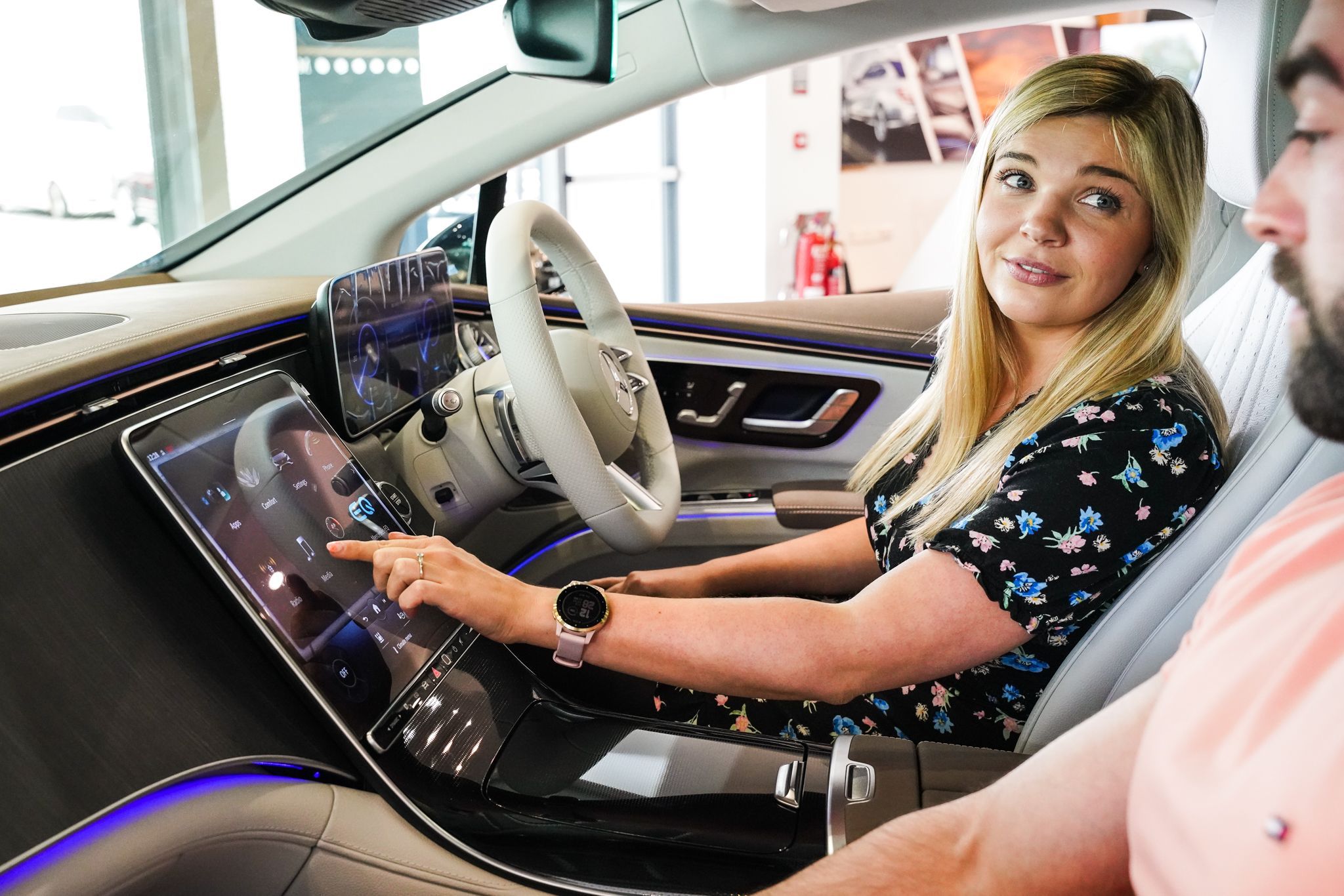 Woman looks at features of her new Motability car
