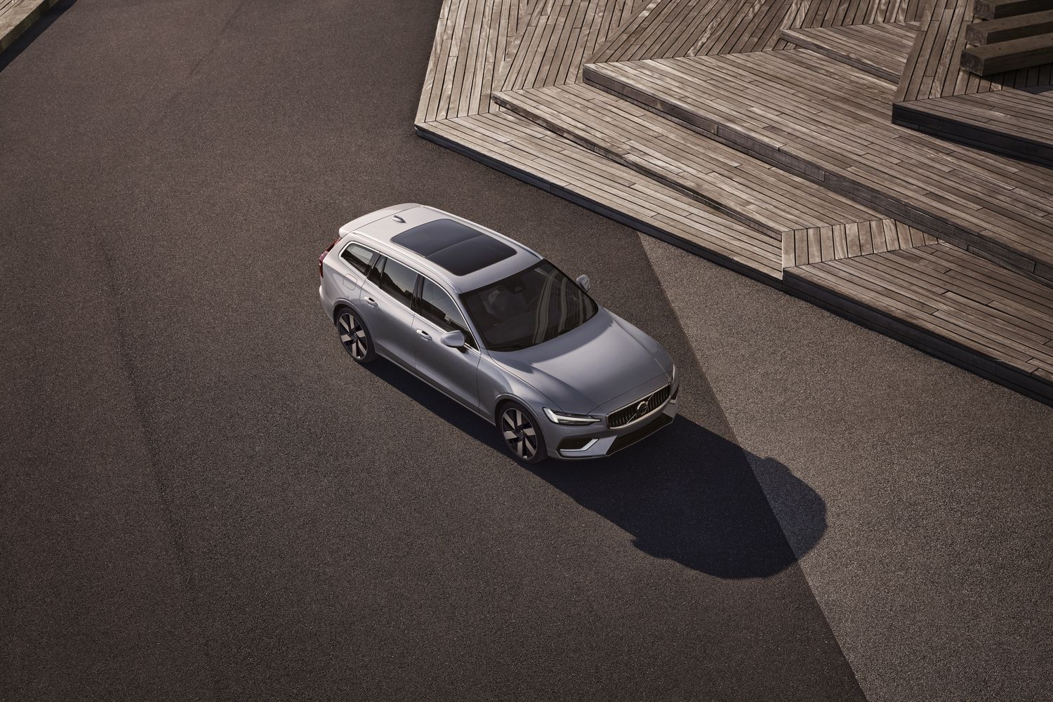 Exterior of the new Volvo V60, available at Agnew Belfast Volvo. Parked outside by a wooden bench.