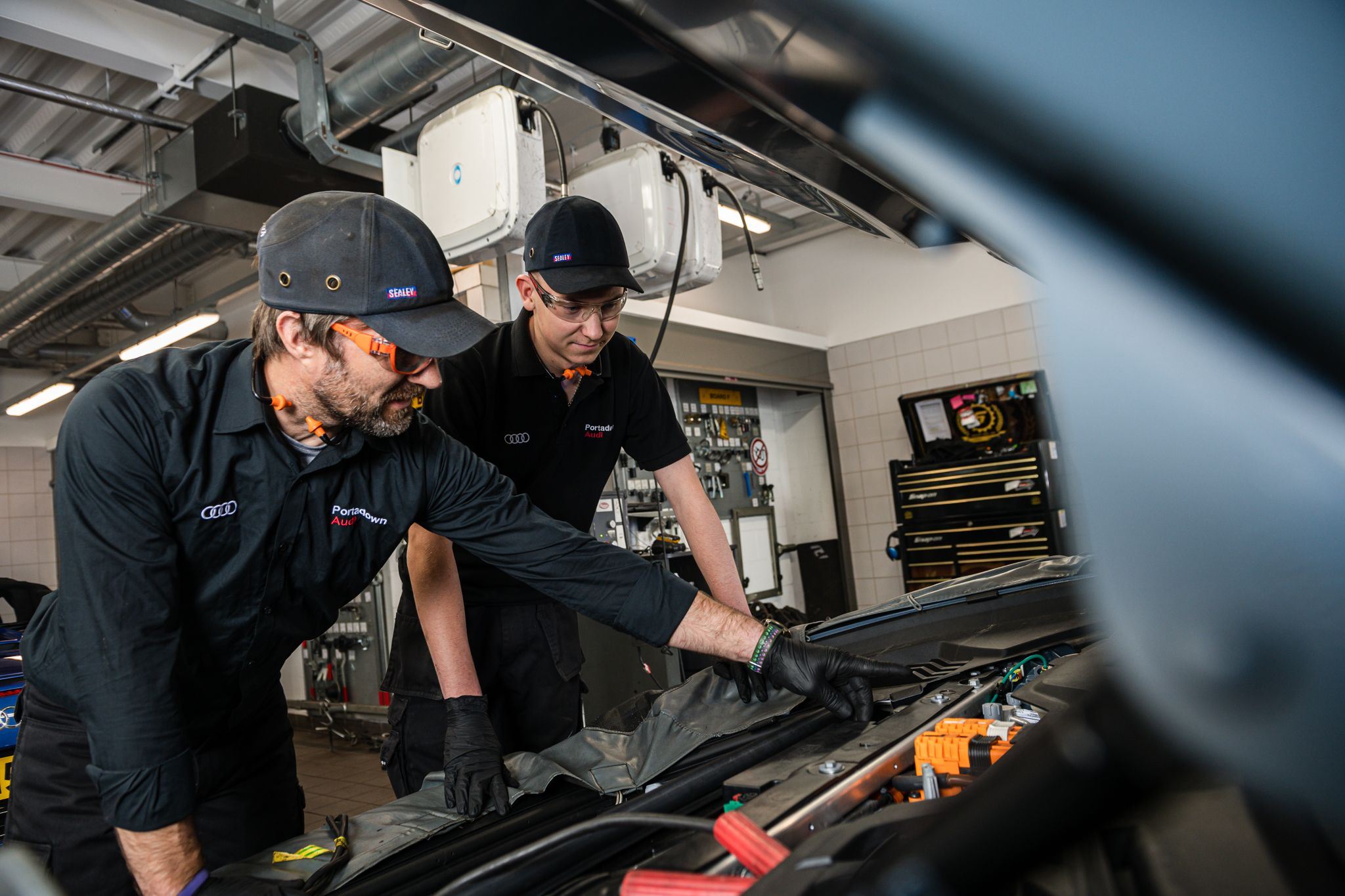 Two Audi Technicians inspect e-tron during service plan inspection at Portadown Audi