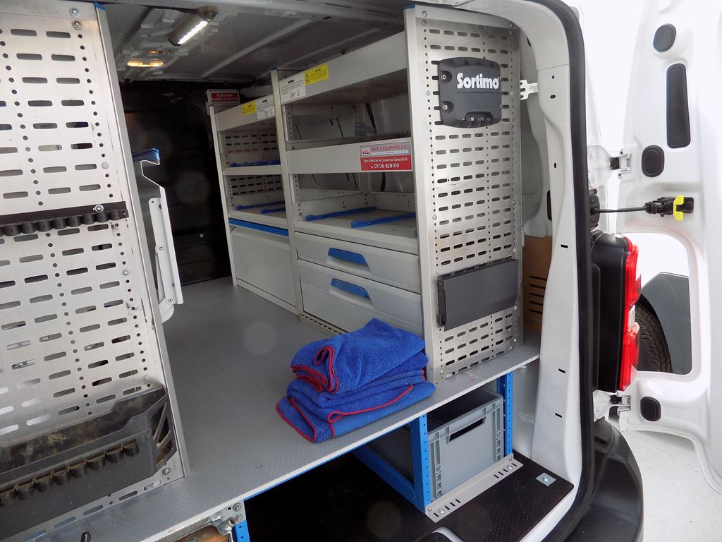Van interior with Sortimo racking system, shelving and pull-out drawers for tool storage.