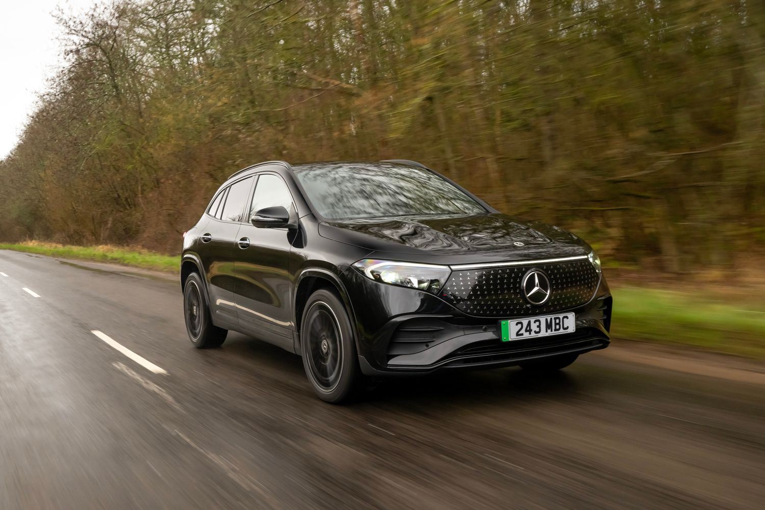 A black Mercedes-Benz EQA driving.