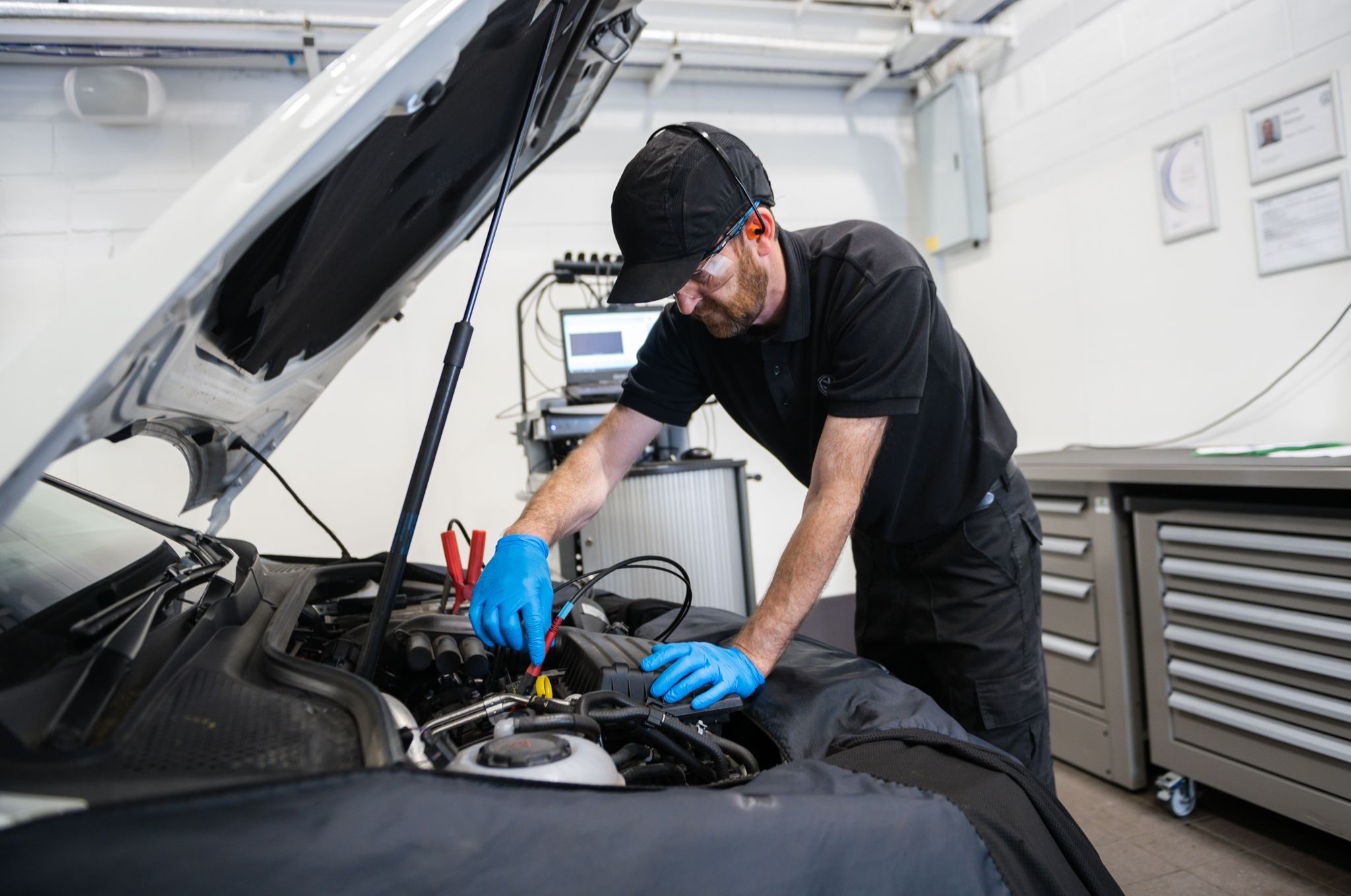 Volkswagen Technician inspects petrol car during Service Plan at Agnew Volkswagen Belfast