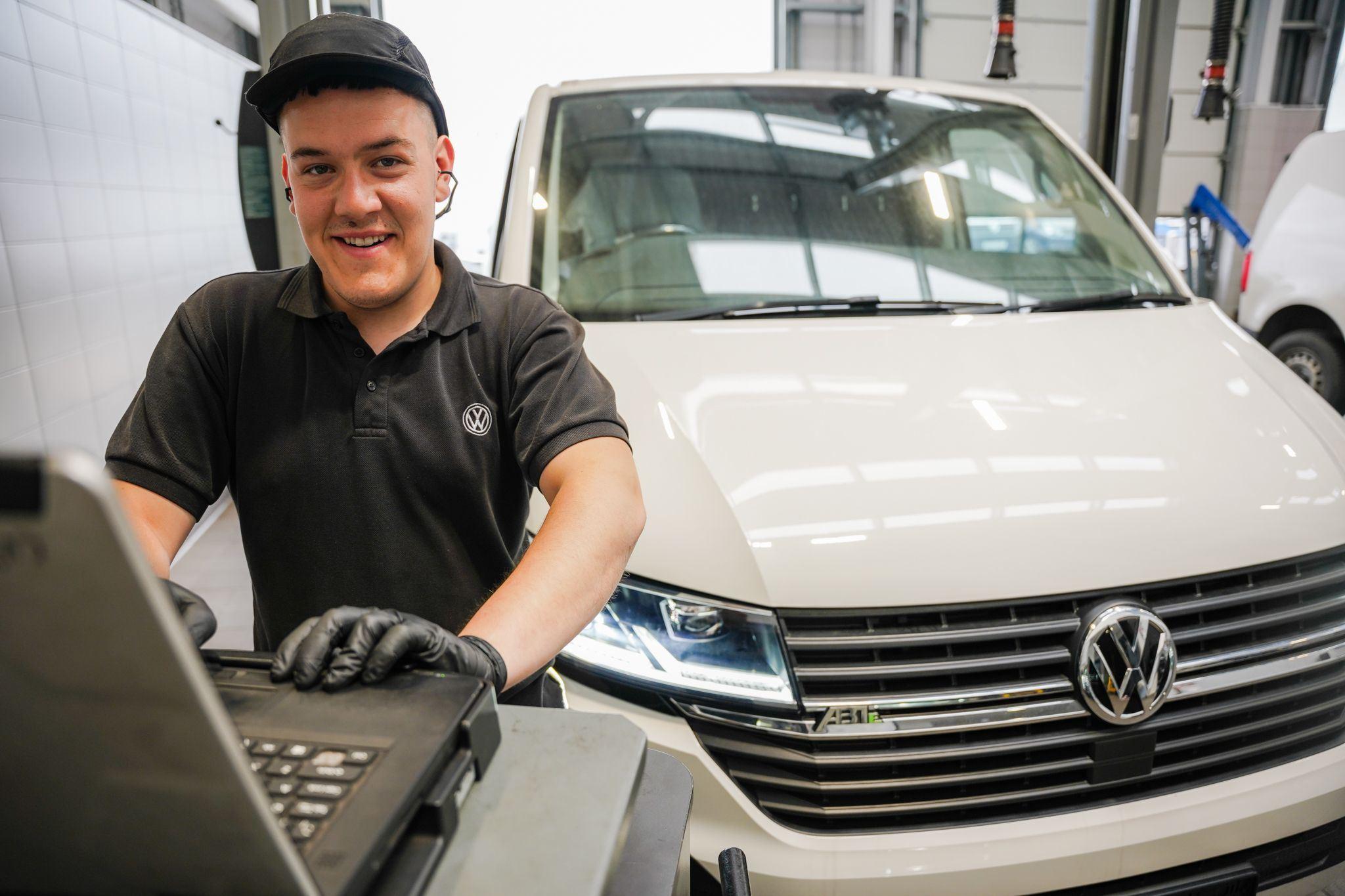 Volkswagen Technician smiles while conducting an intial diagnostic scan on van at Agnew Van Centre