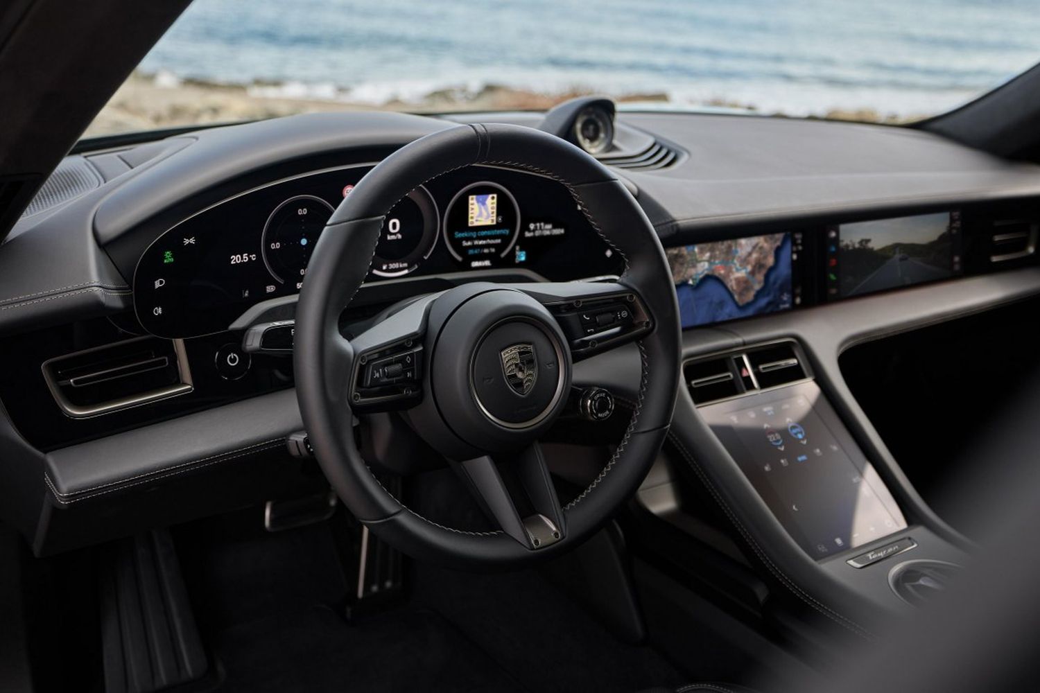 Close-up of the steering wheel and central dashboard of the Porsche Taycan