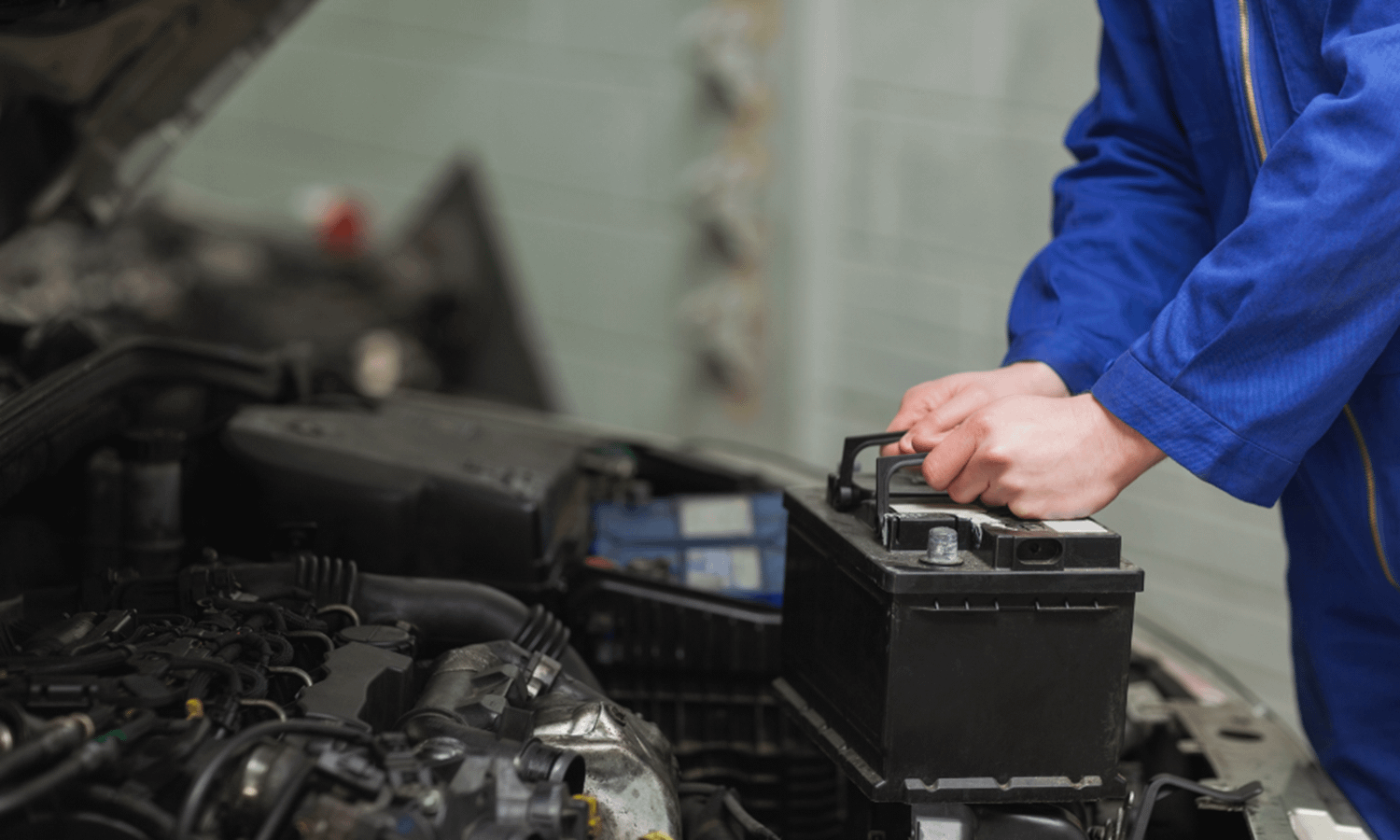 Car battery being replaced by a mechanic