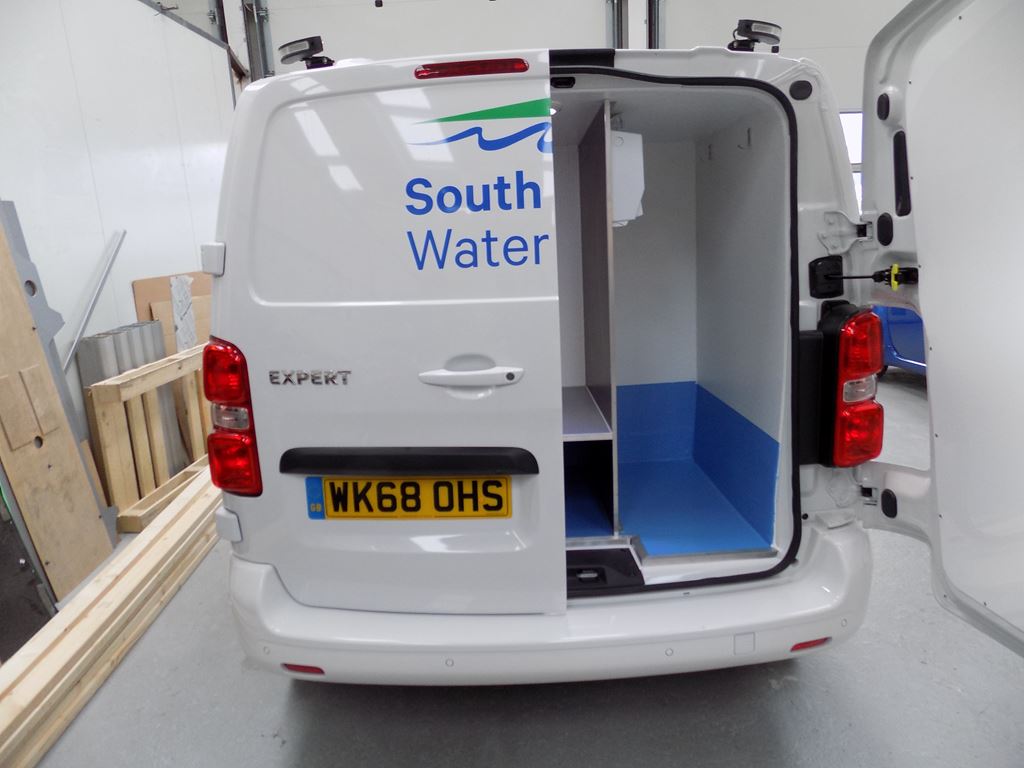 Rear view of South Water van with back doors open, showing fitted internal storage compartment.