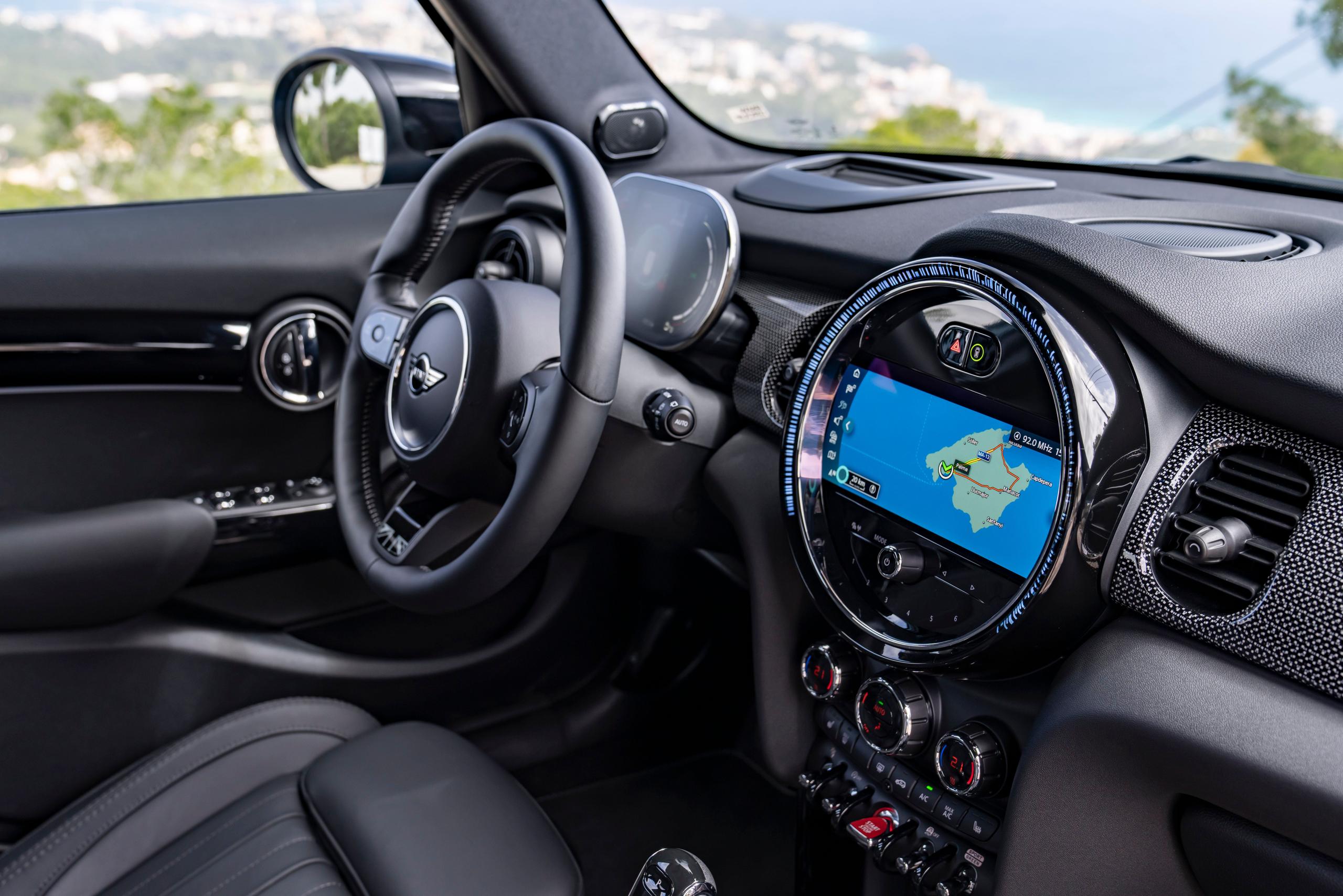 Interior view of the new MINI 5-Door Hatchback in blue, close-up of infotainment system with maps app loaded