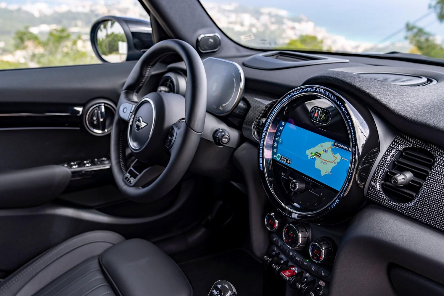 Interior view of the new MINI 5-Door Hatchback in blue, close-up of infotainment system with maps app loaded