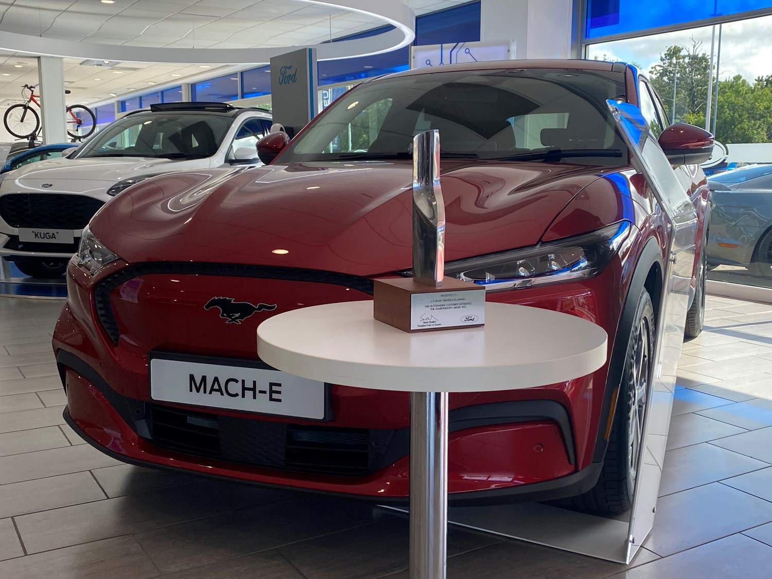 Red Ford Mach E with award