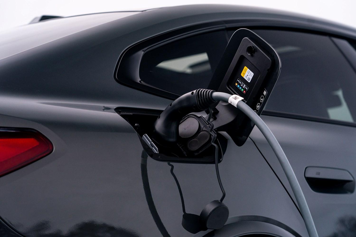 Close-up of the charging port of the BMW 1-Series with charger plugged in