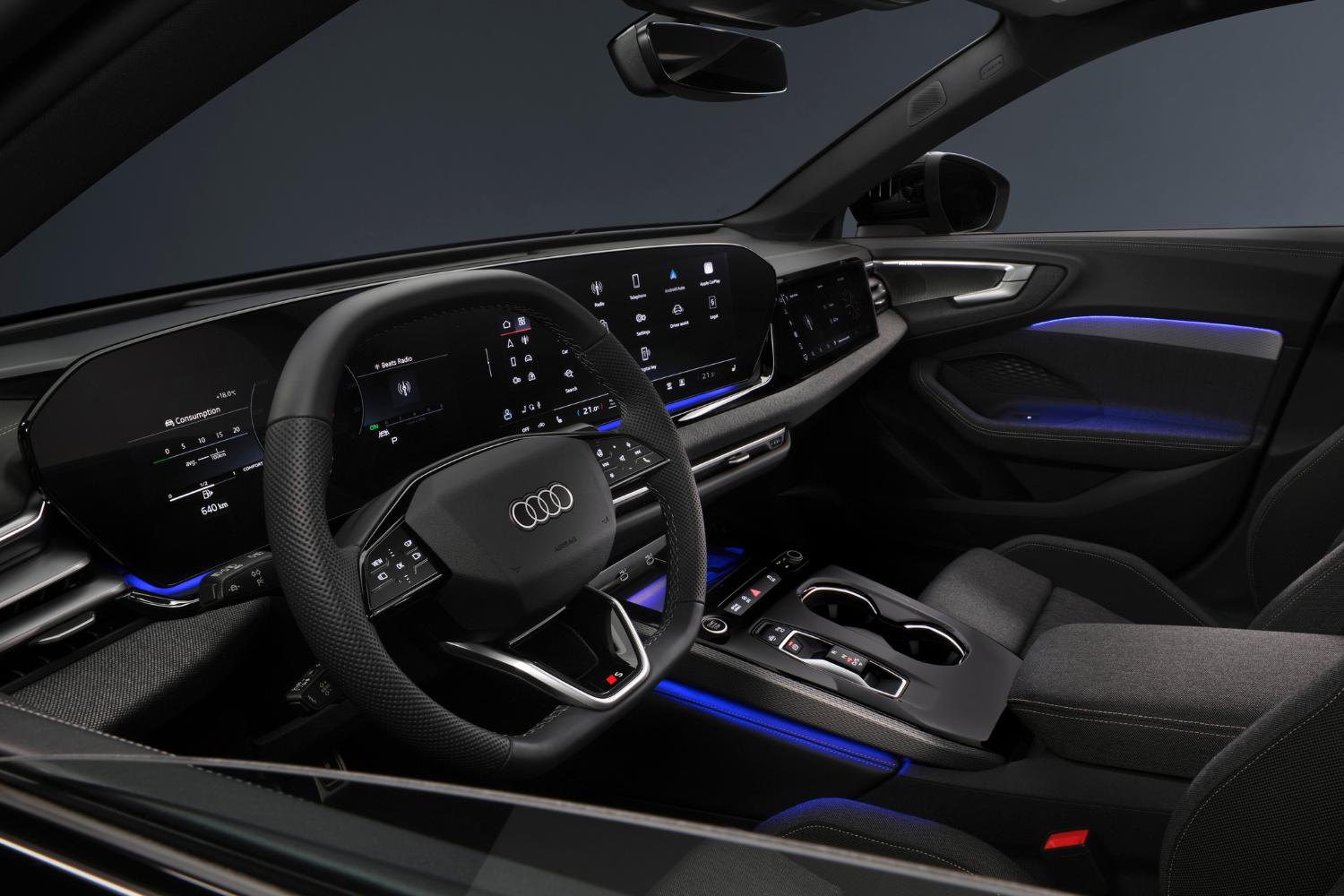 Black interior of the new Audi A5 Saloon featuring blue lights and two driver displays.