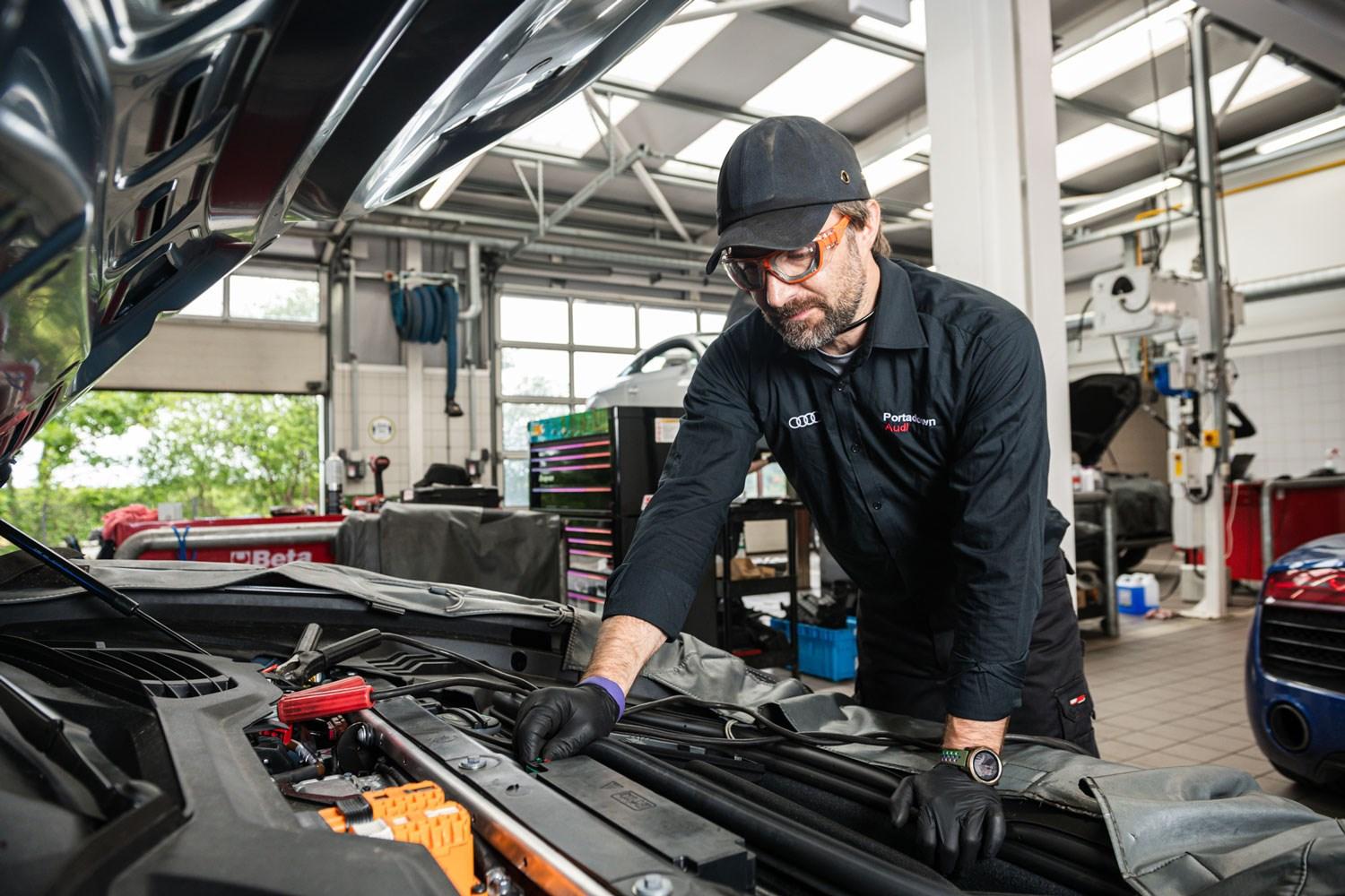 Audi Repair Specialist has the hood up of an Audi A3 while they do a brake fluid change at the Audi Repair Centre in Portadown Audi