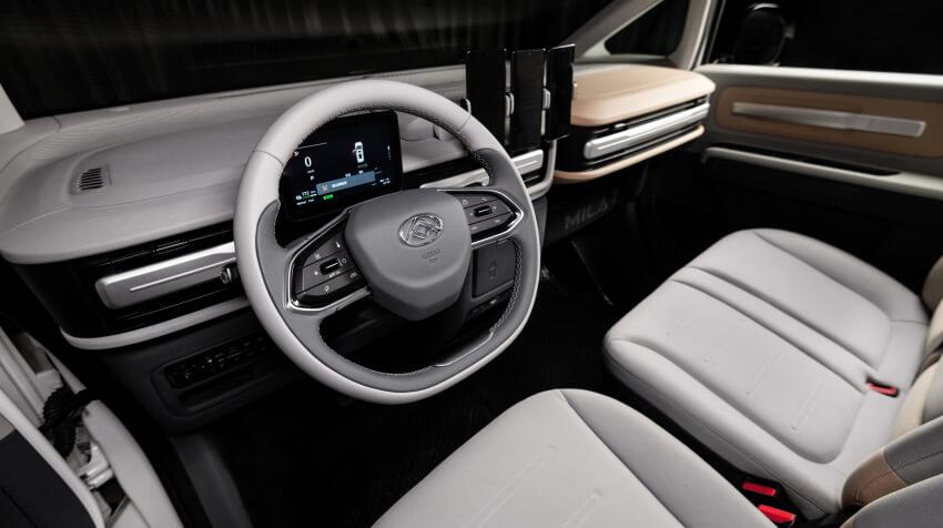 Interior of the Maxus eDeliver 5 showing the steering wheel, digital driver display and front passenger seats.