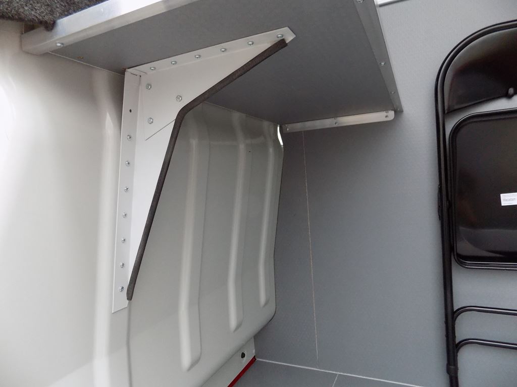 Close-up of van interior showing reinforced shelf bracket on side wall panelling.