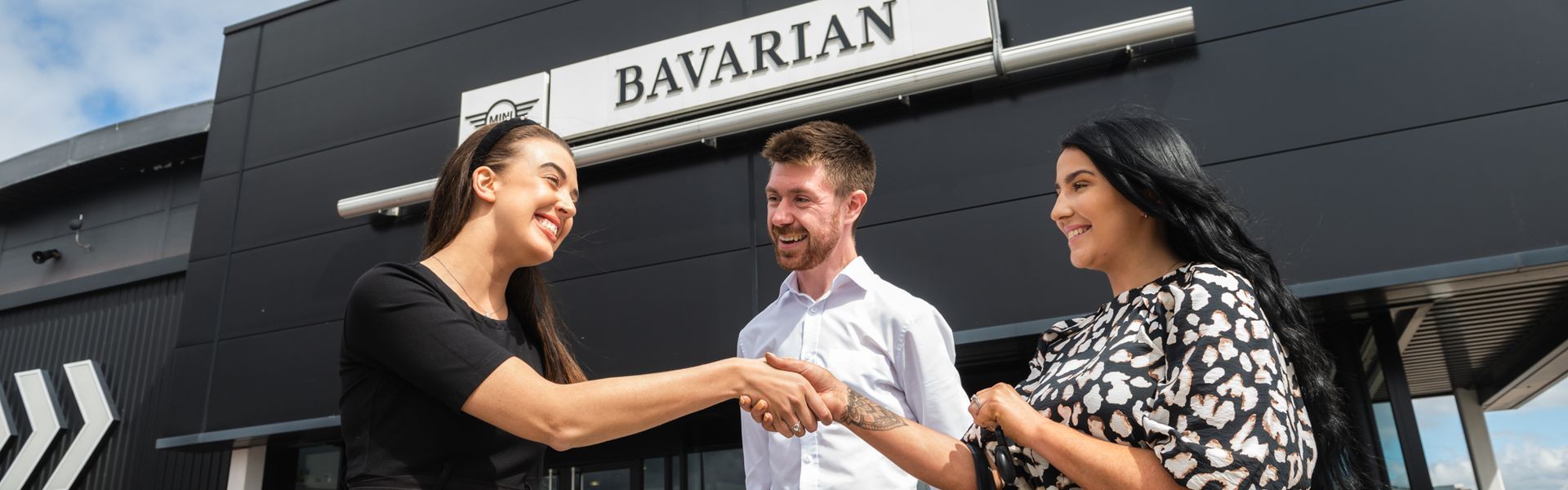Bavarian MINI customer receives the keys to their new car after purchasing a MINI on the MINI Used Car Programme