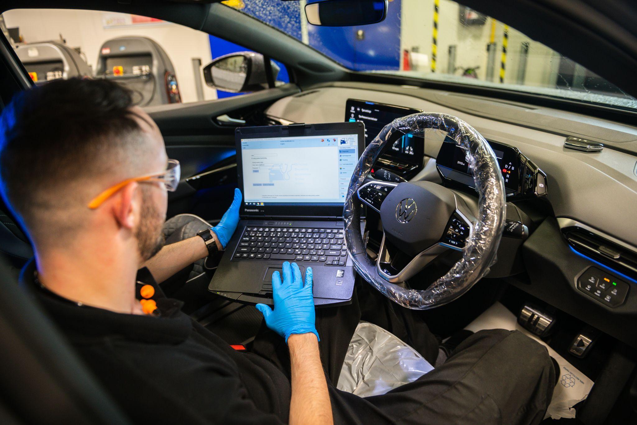 Volkswagen Technician inspects laptop during initial diagnostic scan