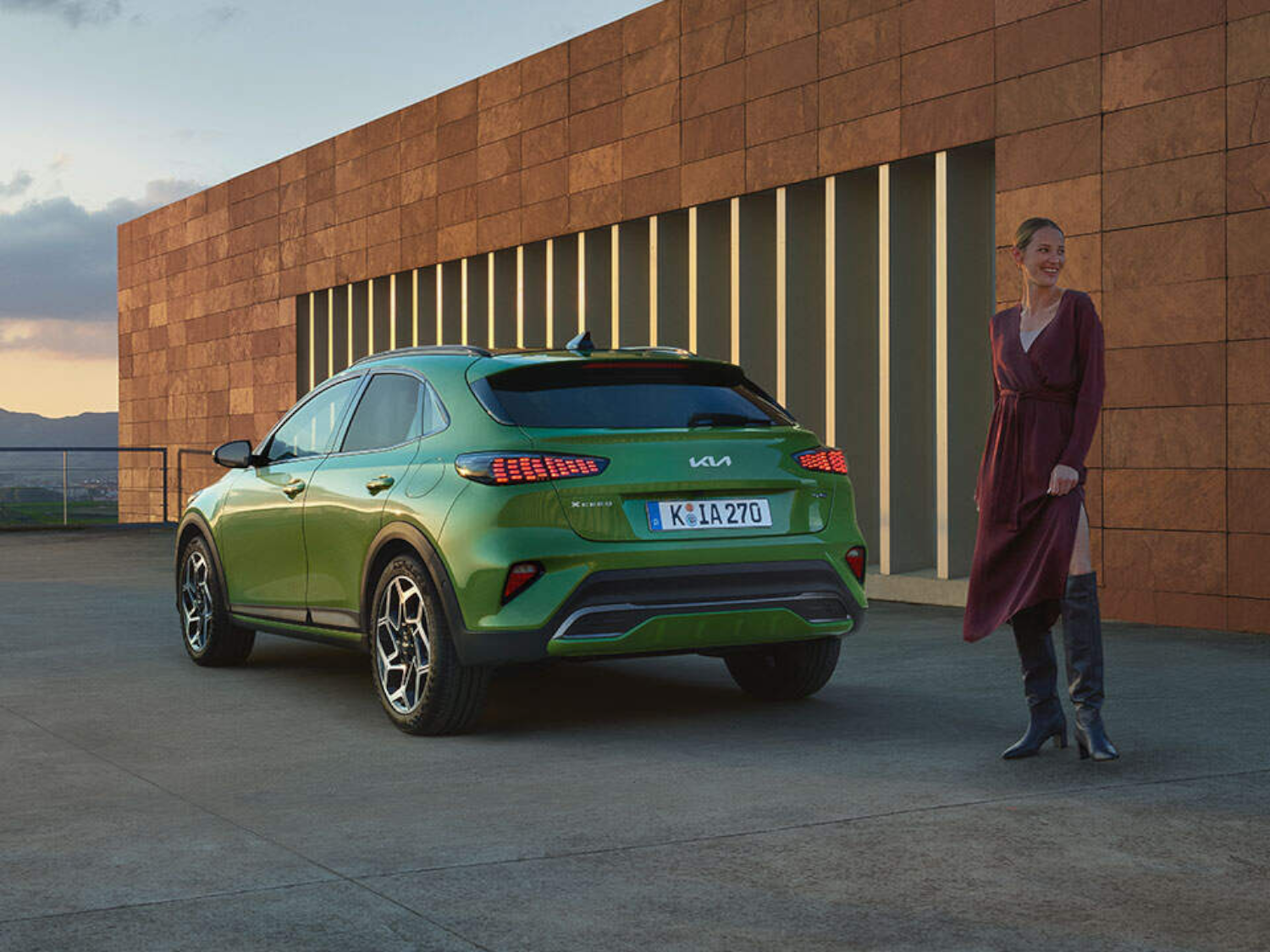woman by a green Kia Xceed