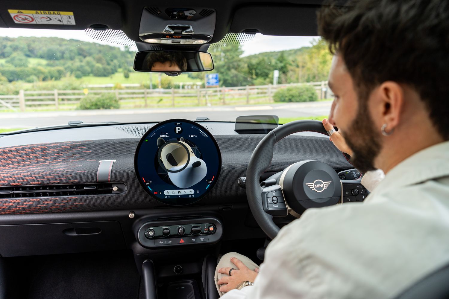 The interior of the new all-electric MINI Cooper, featuring the OLED touchscreen and MINI Intelligent Personal Assistant.