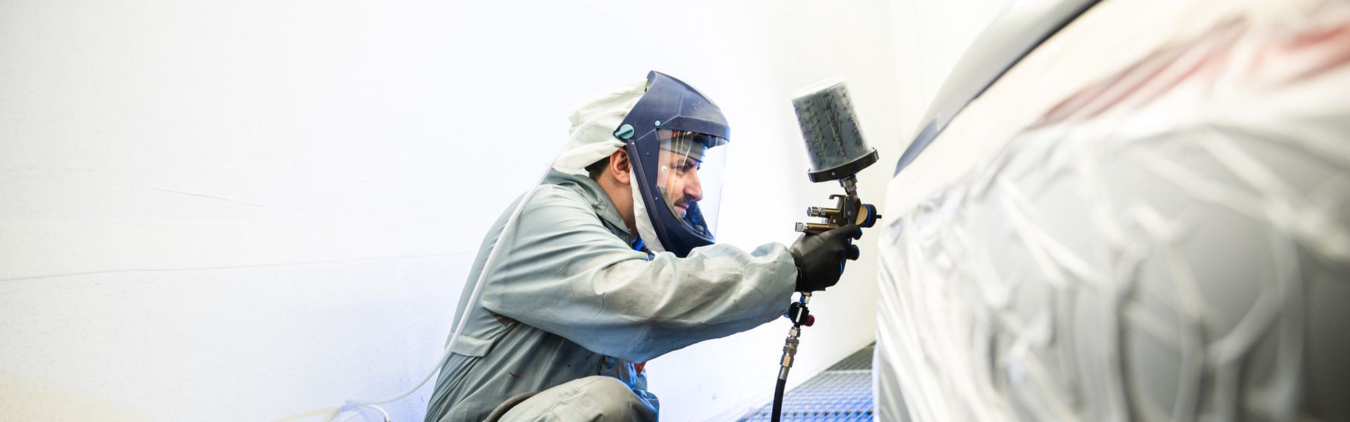 Repair Specialist repairs the paint on a vehicle at the Agnew Repair Centre