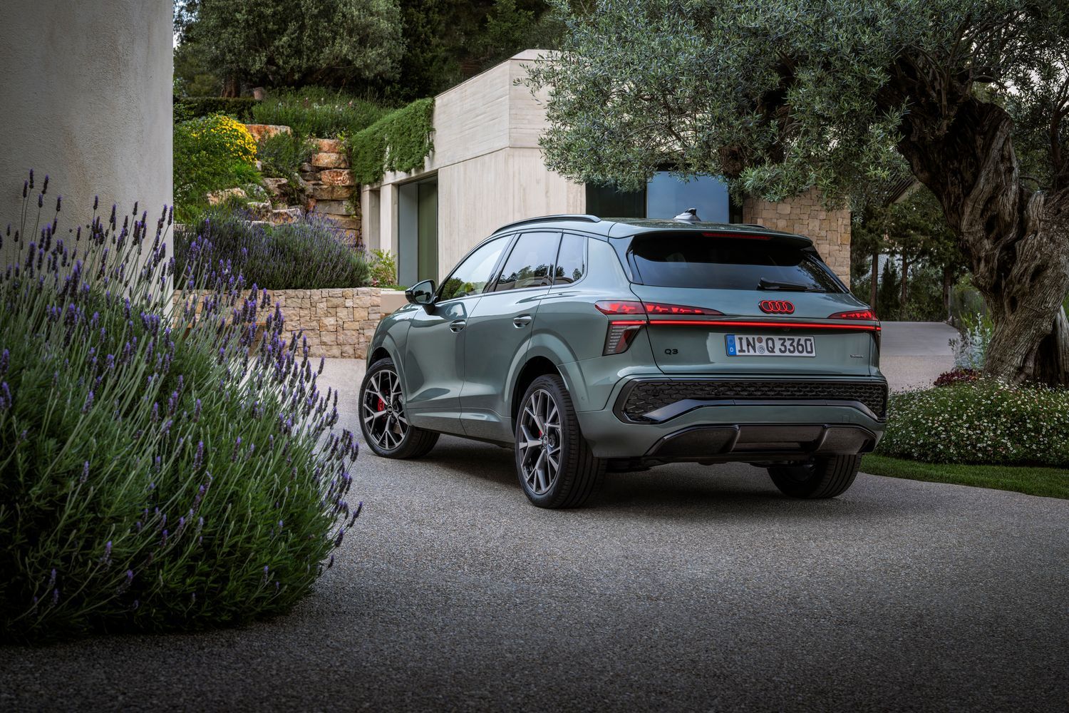 All-New Audi Q3 SUV (in grey) parked outside home