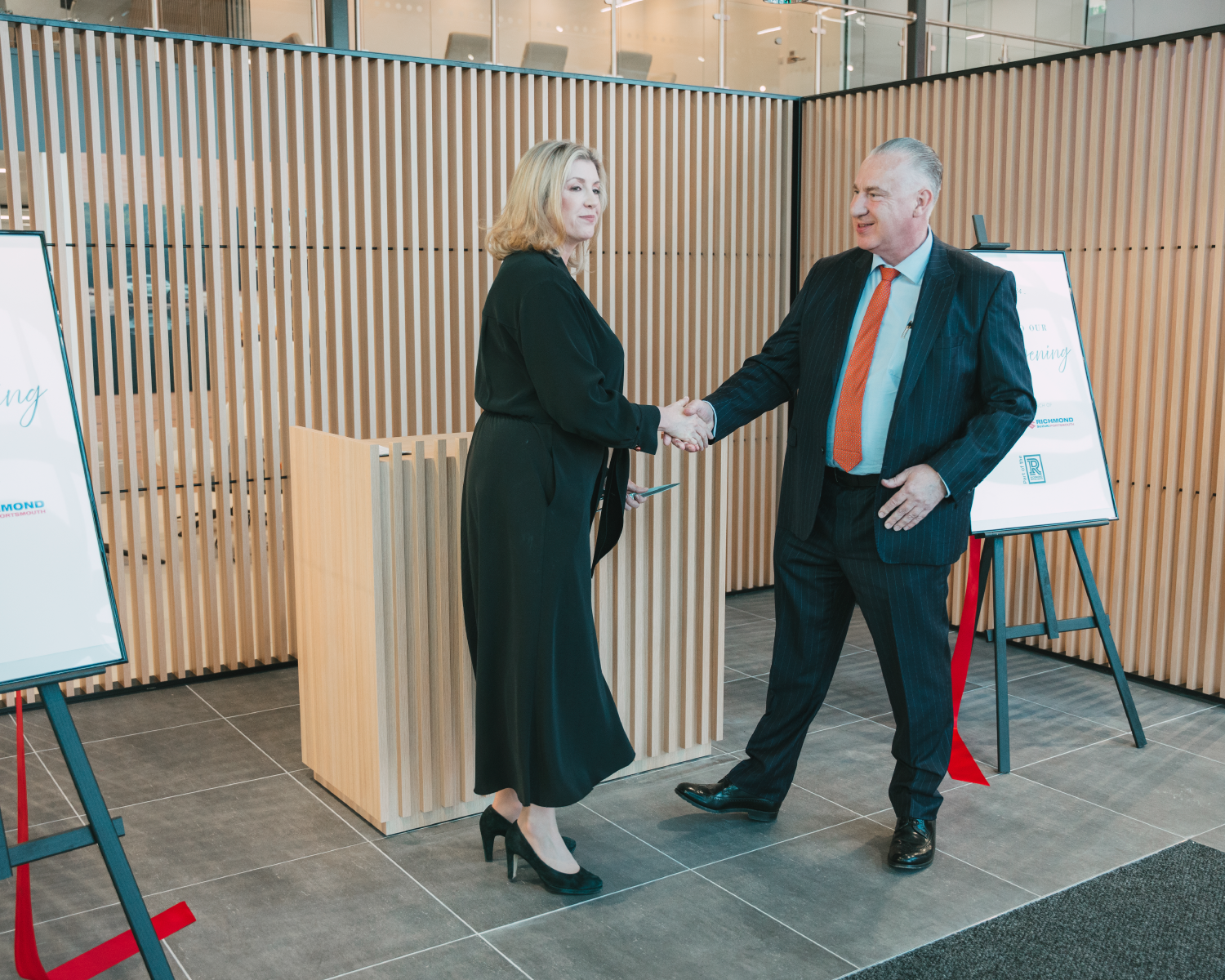 Penny Mordaunt MP shaking hands with the Managing Director of Richmond Motor Group Michael Nobes after cutting the red ribbon