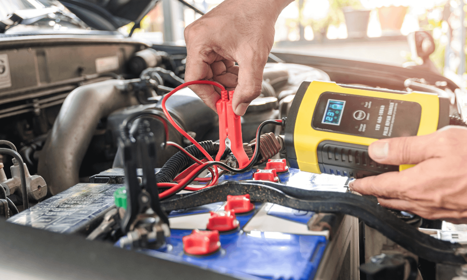 Car battery inspection being carried out by a qualified mechanic