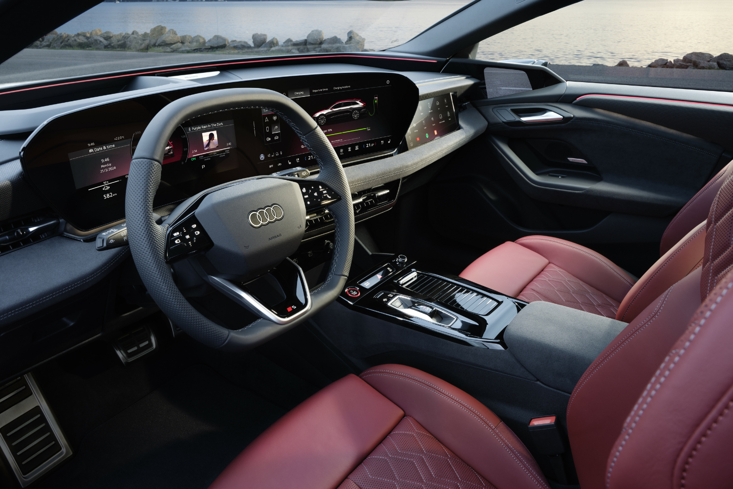 Driver view of the new Audi S6 Avant e-tron driver display and red leather seats.