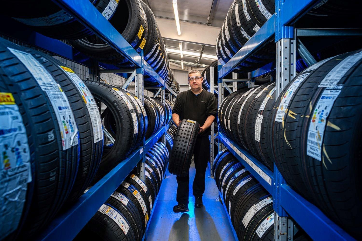 BMW Parts Specialist selects the new tyre for BMW vehicle that is undergoing a repair