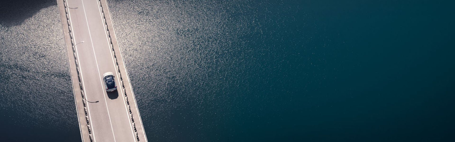 Volvo XC40 with service plan drives on bridge