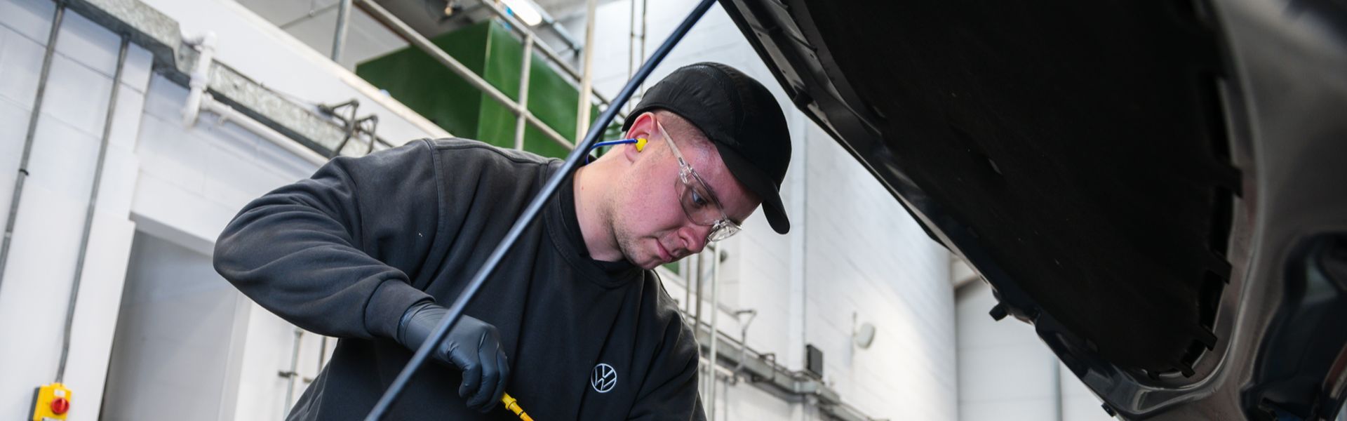 Volkswagen Technician inspects petrol car at Agnew Volkswagen Belfast