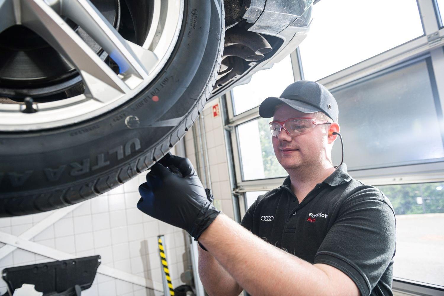 Audi employee checking tyres