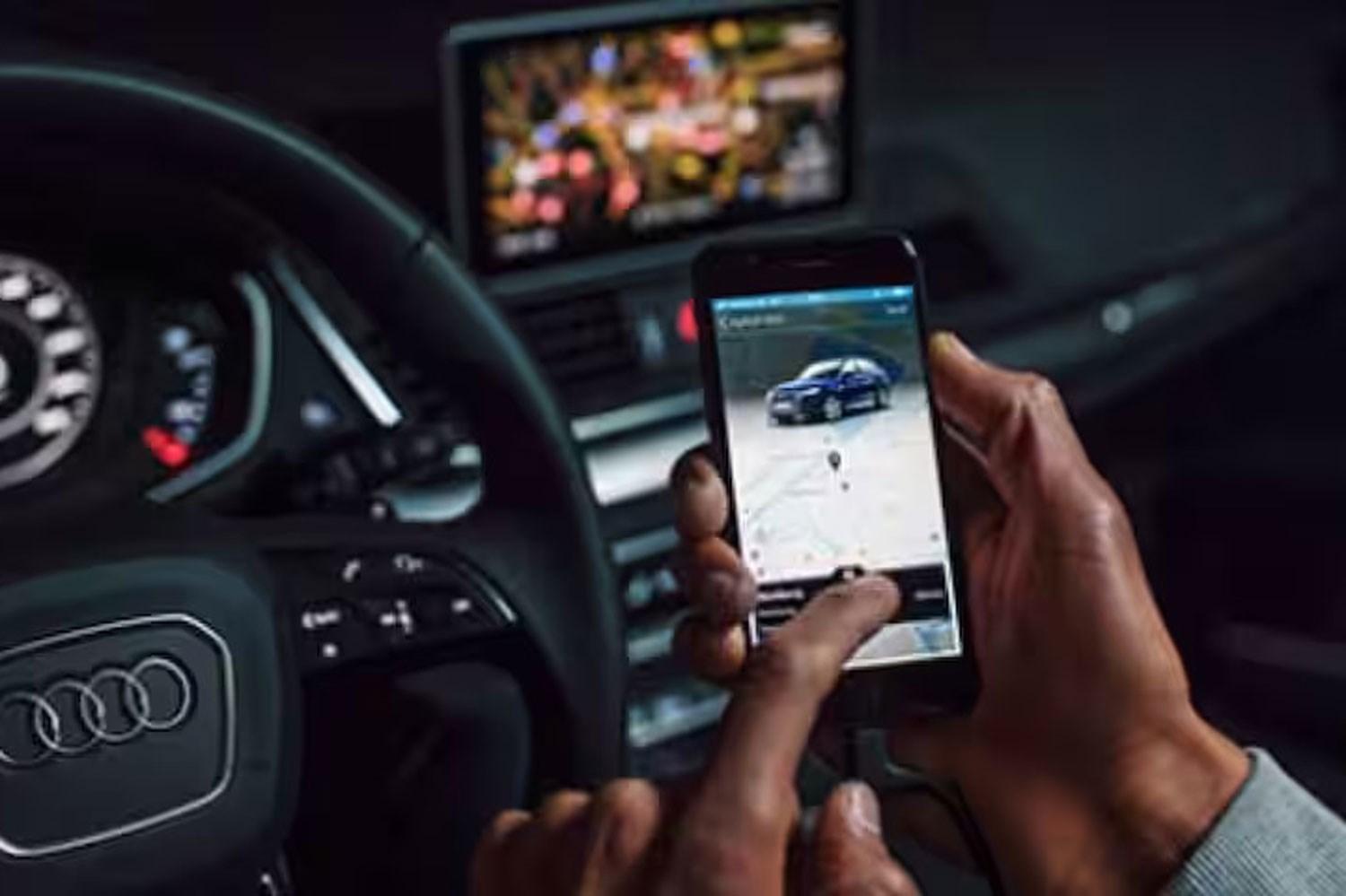 Audi connect infotainment app, image shows Audi driver using the app